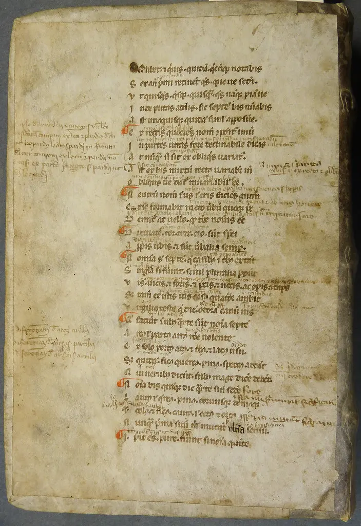 One of two parchment ms. leaves from a copy of Eberhard of Béthune's Graecismus, with marginal and interlinear notes by a reader, used as binder's waste
