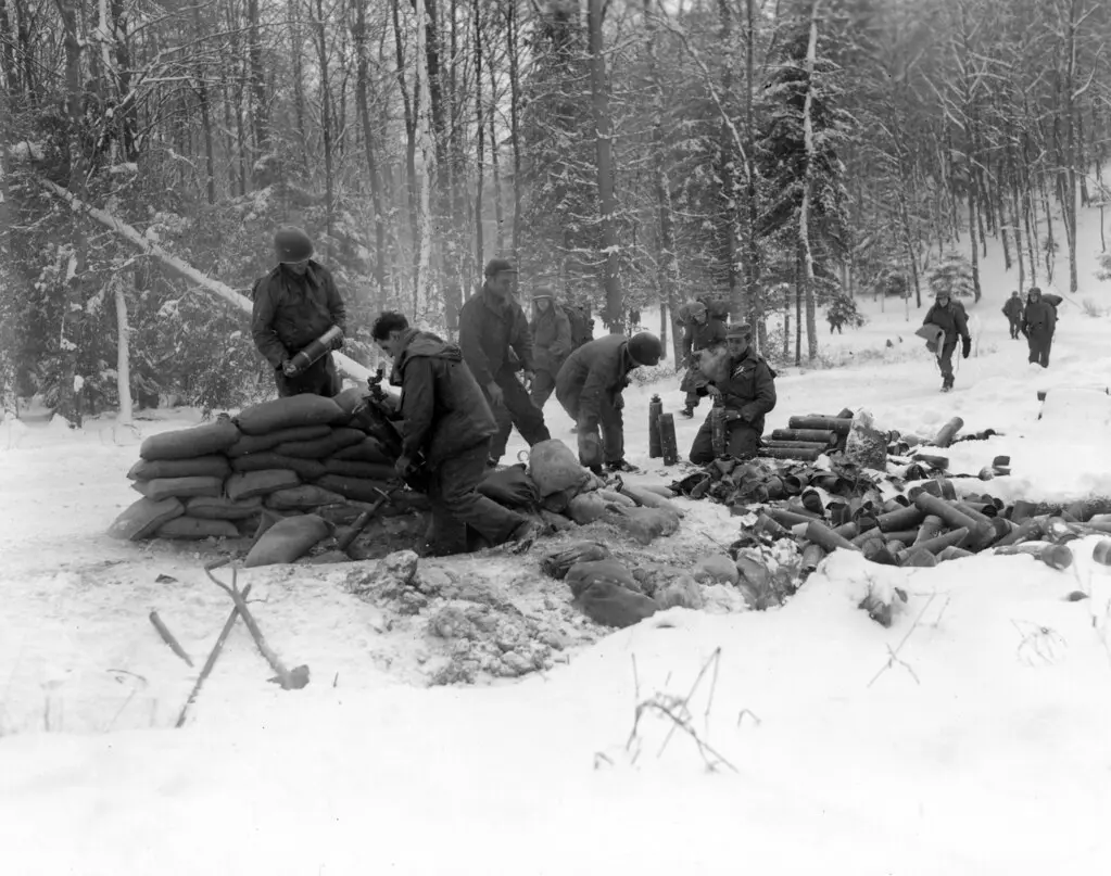 SC 364325 - A 4.2 mortar crew prepares to hurl a harassing barrage of white phosphorous shells on enemy positions to protect the movement of infantrymen (background) moving up to new positions above Wimmenau, France.